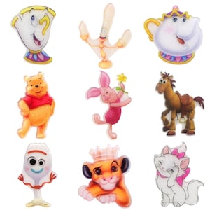 May include: Nine colourful cartoon character iron-on patches. The characters include Winnie the Pooh, Piglet, a teapot, a lamp, a horse, a cat, a fork, and a lion.