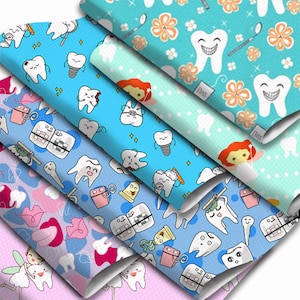 May include: Six different fabric patterns featuring various dental-themed illustrations. The patterns include images of teeth, toothbrushes, braces, and fairies. The fabrics are all in shades of blue, pink, and white.