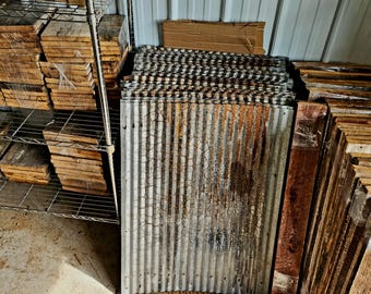 May include: A stack of reclaimed wood planks and corrugated metal sheets, perfect for crafting and DIY projects. The wood planks are various shades of brown and the metal sheets are a weathered gray with rust accents.
