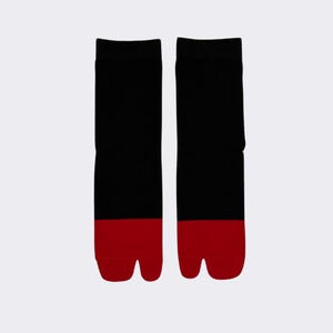 May include: A pair of black tabi socks with red toes. The socks are made of a soft, comfortable material and are perfect for everyday wear.