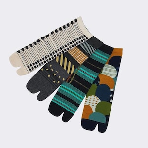 May include: Four pairs of colorful socks with split toes. The socks feature different patterns, including stripes, polka dots, and geometric designs.