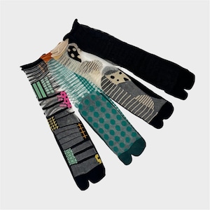 May include: Four pairs of colorful socks with different geometric and abstract patterns. The socks are made of a soft, comfortable material and have a split toe design.