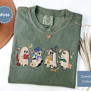 Halloween shirt featuring a cute reading ghosts dressed as wizard houses, perfect for spooky season. This wizard shirt doubles as a fun wizarding school tee or Halloween tee, ideal for Halloween matching, family trips, or Halloween group outfits with a magical twist.