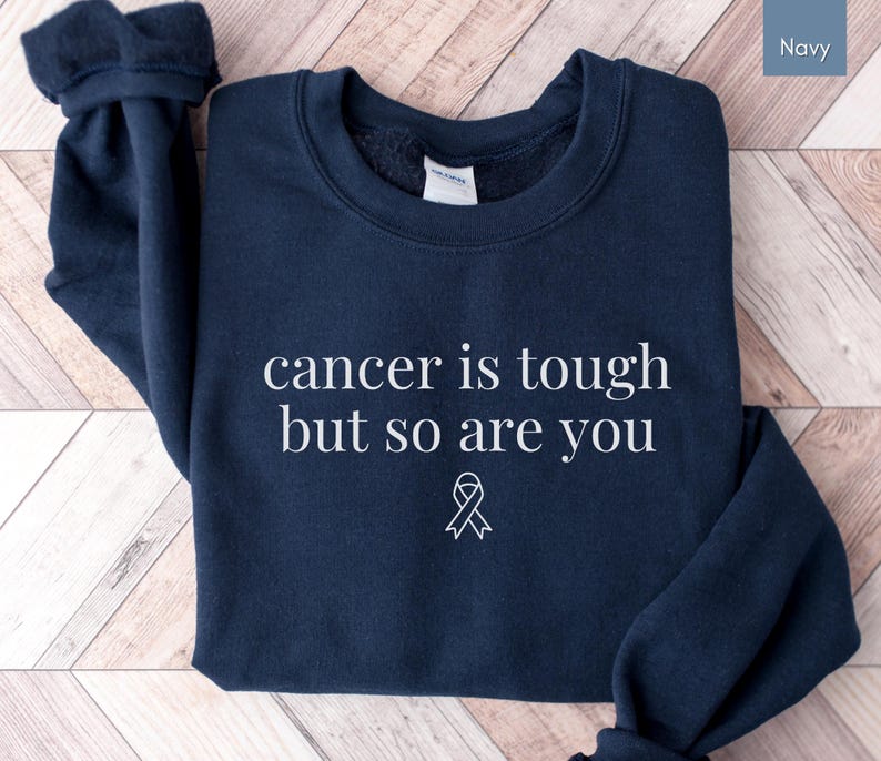 "Cancer is tough but so are you" in a simple text lettering. This Cancer awareness shirt is perfect for healthcare heroes or anyone supporting Breast Cancer Awareness, childhood cancer, cervical cancer and more. Makes a great oncology Nurse Tee or Nurse Tshirt for October events, hospital shifts, cancer encouragement shirt or cancer awareness walks. Show them their fight is out fight with this cancer Ribbon Shirt, not just for nurses or medical assistants.