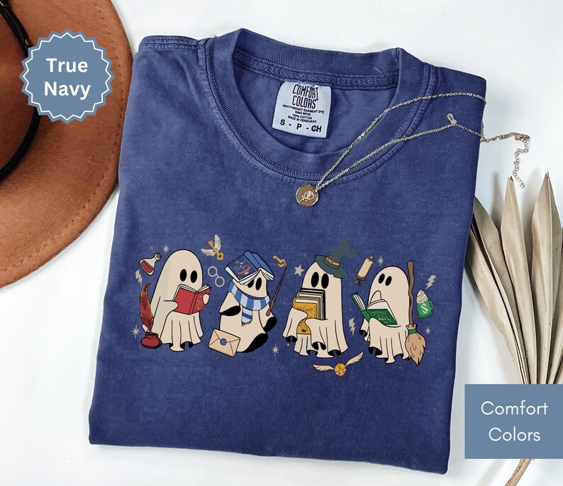 Halloween shirt featuring a cute reading ghosts dressed as wizard houses, perfect for spooky season. This wizard shirt doubles as a fun wizarding school tee or Halloween tee, ideal for Halloween matching, family trips, or Halloween group outfits with a magical twist.