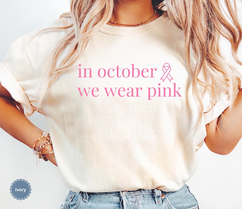 In October We Wear Pink in a simple lettering. This Halloween Tee is perfect for healthcare heroes or anyone supporting Breast Cancer Awareness during spooky season. A thoughtful and festive Oncology Nurse Tee or Cute Nurse Tshirt for October events, hospital shifts, or awareness walks. Celebrate with this Pink Ribbon Shirt designed for nurses or medical assistants who care.