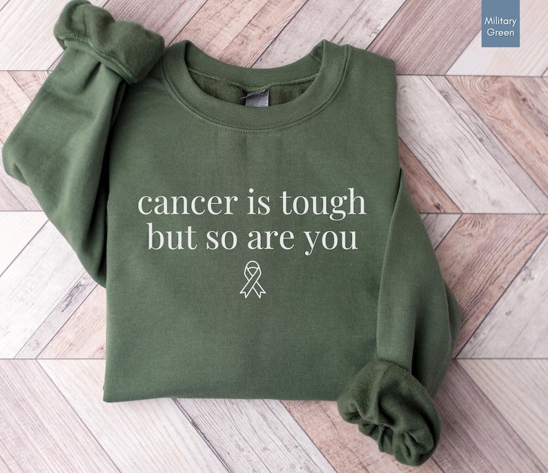 "Cancer is tough but so are you" in a simple text lettering. This Cancer awareness shirt is perfect for healthcare heroes or anyone supporting Breast Cancer Awareness, childhood cancer, cervical cancer and more. Makes a great oncology Nurse Tee or Nurse Tshirt for October events, hospital shifts, cancer encouragement shirt or cancer awareness walks. Show them their fight is out fight with this cancer Ribbon Shirt, not just for nurses or medical assistants.
