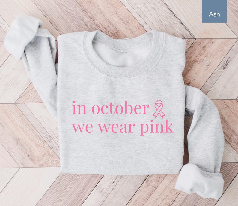 In October We Wear Pink in a simple lettering. This Halloween Tee is perfect for healthcare heroes or anyone supporting Breast Cancer Awareness during spooky season. A thoughtful and festive Oncology Nurse Tee or Cute Nurse Tshirt for October events, hospital shifts, or awareness walks. Celebrate with this Pink Ribbon Shirt designed for nurses or medical assistants who care.