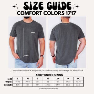 May include: A size guide for Comfort Colors 1717 t-shirts. The image shows a model wearing the shirt, with front and back views. The guide includes measurements in inches for width and length, ranging from size S to 4X. The text also states the model is 6'0, weighs 180 lbs, and wears a size Large.