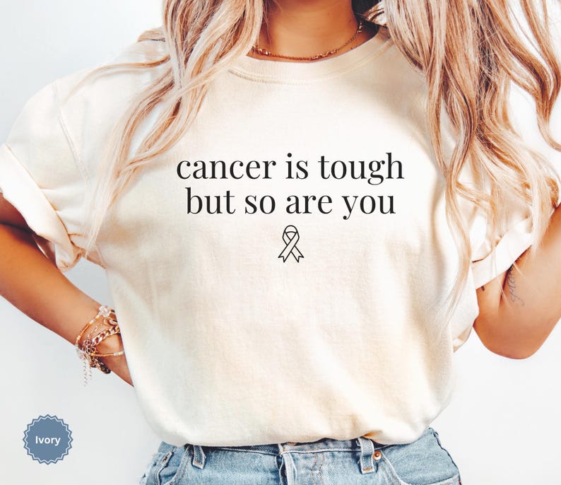 "Cancer is tough but so are you" in a simple text lettering. This Cancer awareness shirt is perfect for healthcare heroes or anyone supporting Breast Cancer Awareness, childhood cancer, cervical cancer and more. Makes a great oncology Nurse Tee or Nurse Tshirt for October events, hospital shifts, cancer encouragement shirt or cancer awareness walks. Show them their fight is out fight with this cancer Ribbon Shirt, not just for nurses or medical assistants.