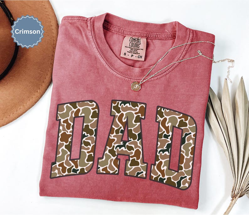 Cool and rugged Camo Dad Shirt designed for the ultimate Hunting Dad—perfect as a New Dad Father's Day Gift or Dad Birthday Gift. This comfortable and stylish Camouflage Dad Shirt makes a great Gift for Dad who loves the outdoors. A must-have Dad Tee for everyday wear, this Dad Tshirt is a top pick for any proud papa. Whether you're shopping for a Dad Gift or the Best Dad Gift, this shirt delivers both style and sentiment.