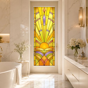 May include: A rectangular door featuring a stained glass panel with a geometric sunburst design. The glass displays vibrant yellow, orange, and purple segments arranged in a radiating pattern, set within a light-colored frame in a bathroom.