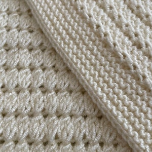 May include: Two pieces of white crocheted fabric, one with a simple stitch and the other with a more intricate pattern.