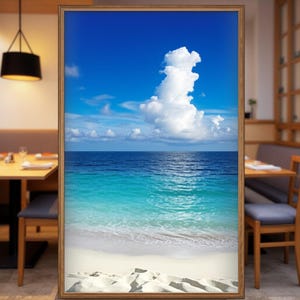 May include: A framed print featuring a vibrant beach scene. The image showcases a bright blue sky with fluffy white clouds above a turquoise ocean. A white sandy beach is in the foreground, creating a serene coastal landscape.