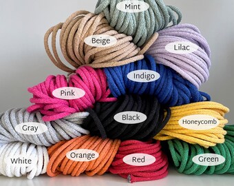 May include: A collection of coiled cotton cord in various colours including mint, beige, lilac, pink, indigo, black, honeycomb, grey, white, orange, red, and green. Each coil is labelled with its corresponding colour name in white text.