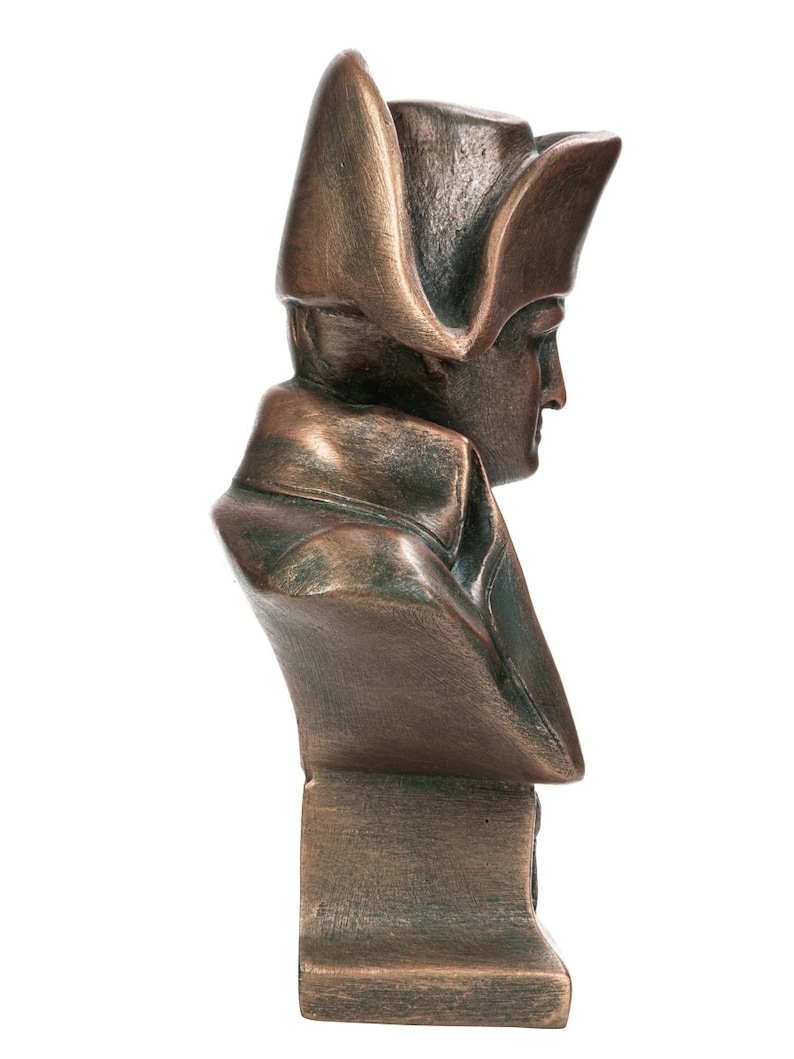 May include: A bronze bust sculpture of a man wearing a bicorne hat. The bust is on a square base.