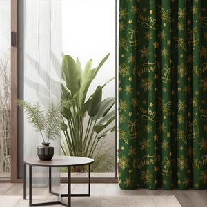 May include: Green Christmas curtain with gold snowflakes, gift boxes, stars, and the words "Merry Christmas" in a script font. The curtain is hanging in front of a window with a view of plants and a small table with a vase.