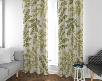 May include: A pair of floor-length curtains featuring a repeating pattern of green fern-like leaves on a light beige background. The curtains are hung from a silver metal rod with circular grommets at the top, creating vertical folds.