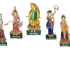 May include: Set of nine colorful wooden figurines depicting women in traditional Indian clothing. Each figurine has a unique design and is labeled with a name in Hindi.