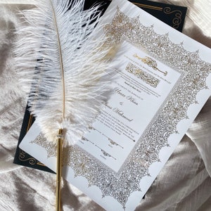 May include: A white and gold Islamic marriage certificate with intricate calligraphy and a decorative border. The text reads "In the name of Allah, The Most Gracious and The Most Merciful" and "Is to certify the marriage of Umar Khan & Anna Mahmood".