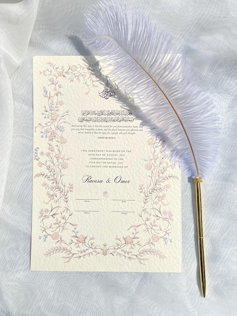 May include: A wedding certificate with floral border and text, "THIS AGREEMENT WAS MADE ON THE 20TH DAY OF AUGUST, 2021...TO CERTIFY THE MARRIAGE OF Racesa & Omer." A white feather pen with a gold-coloured tip rests on the certificate.
