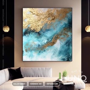 May include: A square wall art canvas featuring an abstract composition of swirling teal, turquoise, and white paint blended with textured metallic gold leaf accents. The artwork displays a fluid, layered appearance with deep blue and white gradients.
