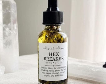 May include: A glass dropper bottle filled with golden oil and herbs, featuring a white label that reads Magick & Sage HEX BREAKER RITUAL OIL. The bottle is surrounded by two clear quartz points, a cluster of clear quartz, and a black stone.