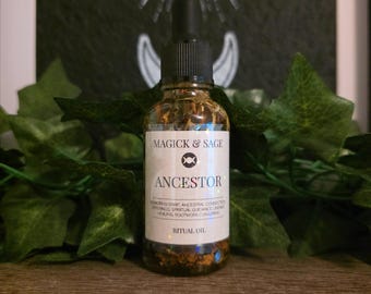 May include: A clear glass dropper bottle containing amber-colored ritual oil with visible botanical inclusions. The white label features the text MAGICK & SAGE, a triple moon symbol, and the word ANCESTOR, followed by smaller descriptive text.