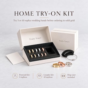 May include: A home try-on kit featuring a white box with the text Truly Yours, containing multiple metal replica wedding bands in gold, silver, and rose gold tones. Includes a black ring sizer tool and a set of loose rings on the side.
