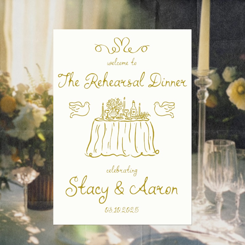 May include: A white sign with gold lettering announcing "The Rehearsal Dinner" celebrating "Stacy & Aaron" on 08.10.2025. The sign features a hand-drawn illustration of a table setting with a floral centerpiece, candles, and two doves.