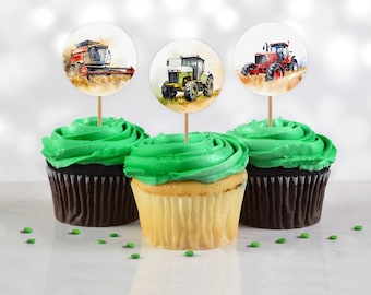 May include: Three cupcakes with green frosting and farm vehicle toppers. The toppers are round and feature a red tractor, a green tractor, and a red combine harvester.