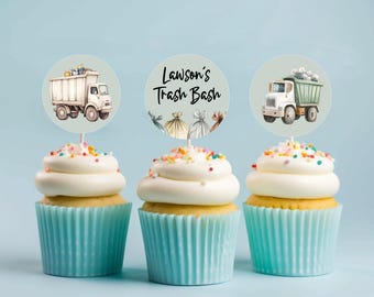 May include: Three blue and white cupcakes with colorful sprinkles on top. Each cupcake has a round, paper cupcake topper with a cartoon illustration of a garbage truck and the text "Lawson's Trash Bash".