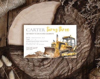 May include: A yellow construction birthday party invitation with a cartoon illustration of a bulldozer. The invitation says "Carter turns three" and includes the date, time, and location of the party.