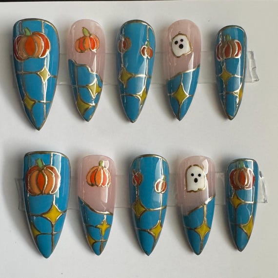 20 Halloween Nail Ideas With Ghosts, Bats and Spooky Details 6 Blue Stained-Glass Pumpkins