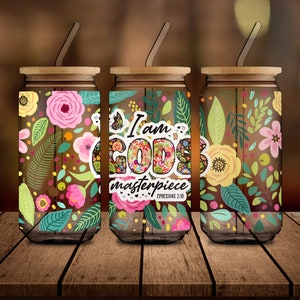 May include: Three glass canisters with wooden lids and colorful floral patterns. The middle canister has a sticker that says "I am God's masterpiece Ephesians 2:10".