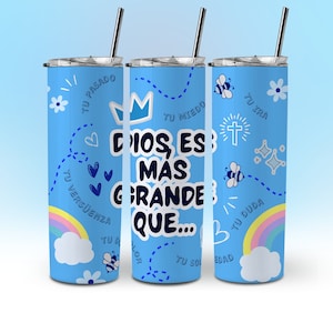 May include: A blue stainless steel tumbler with a white and blue design. The tumbler features the text "Dios es mas grande que..." with various illustrations including hearts, bees, a crown, a cross, and a rainbow.