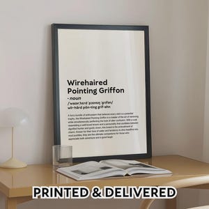 May include: A framed print with the text "Wirehaired Pointing Griffon" in black font. The print includes a definition and description of the breed. The words "PRINTED & DELIVERED" are at the bottom.