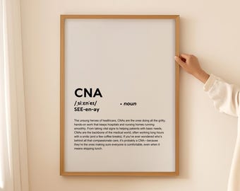 May include: A framed print with a white background and black text defining the word "CNA" as a noun. The text explains that CNAs are the unsung heroes of healthcare, working in hospitals and nursing homes, taking vital signs, helping patients with basic needs, and providing compassionate care.