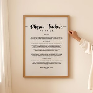 May include: A framed wall art print titled Physics Teacher's Prayer, featuring black text on a white background. The prayer expresses a desire for insight, patience, and the ability to inspire students, ending with the word Amen in a light wood frame.