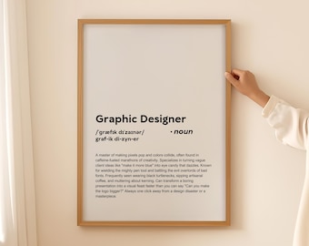 May include: A framed print with a white background and black text defining the term "Graphic Designer". The text includes the phonetic pronunciation and a definition of the role, describing the skills and personality traits of a graphic designer.