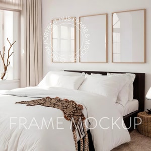 May include: A white bed with a brown and black patterned throw blanket. Two wooden picture frames are hanging on the wall above the bed. The frames are empty and ready for your artwork.