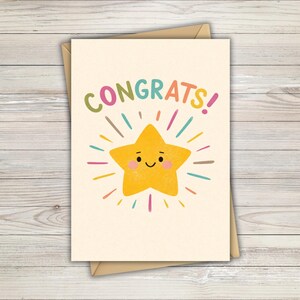 May include: A cream-coloured greeting card with the word "CONGRATS!" in colourful letters. A smiling yellow star with radiating lines and colourful accents is featured on the card. The card is inside a brown envelope.