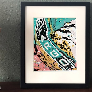 May include: A framed print of a colorful illustration of a ship with the word "FARGO" written on the side. The ship is surrounded by yellow, black, and white clouds. The print is on a white background and has a black frame.