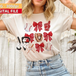 May include: White t-shirt with a red, white, and blue baseball theme design. The design includes baseballs, bats, gloves, bows, and a number one finger. The text "#1" is on the finger.