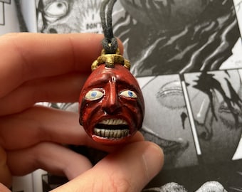 Berserk | egg of the king ( behelit) polymer clay necklace with stand
