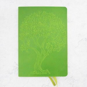 May include: A green notebook with a tree design embossed on the front cover. The notebook has a green ribbon bookmark.