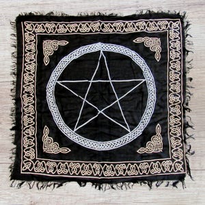 May include: Black cotton fabric with a white pentagram and a silver circle border. The fabric has a gold Celtic knot border.