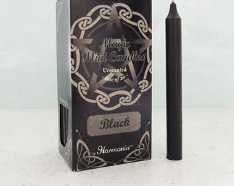 May include: A black box of "Magic Mini Candles" with a pentagram design and the word "Black" on the front. A single black candle stands next to the box. The box says "Unscented Box of 20" and "Harmonia".
