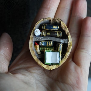 Miniature Walnut Shell Reading Nook: Enchanting Micro Library with Ancient Manuscript for Book Lovers