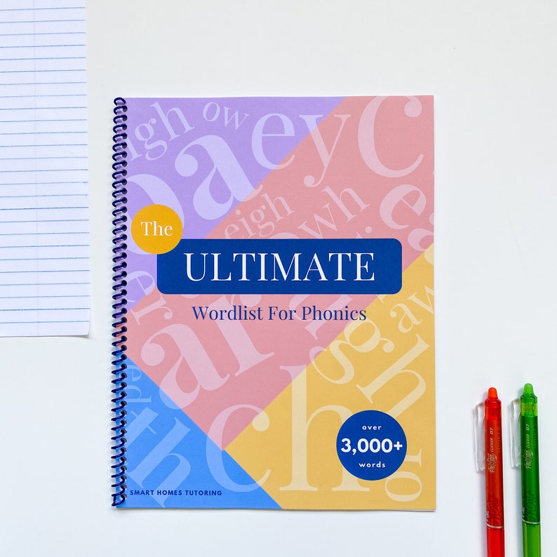 May include: A blue, pink, yellow, and purple spiral bound book titled "The Ultimate Wordlist For Phonics" with the text "over 3,000+ words" in a yellow circle. The book cover features a colorful design with overlapping letters.